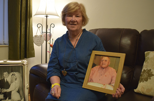 Margaret, holding a picture of her husband Gordon