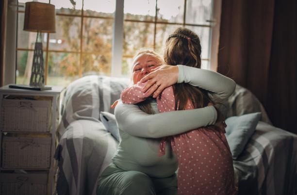 Woman hugging her granddaughter