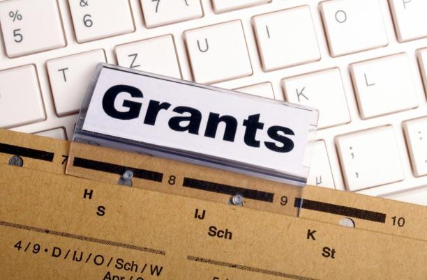 A stock photo showing a folder highlighting Grants applications on a keyboard