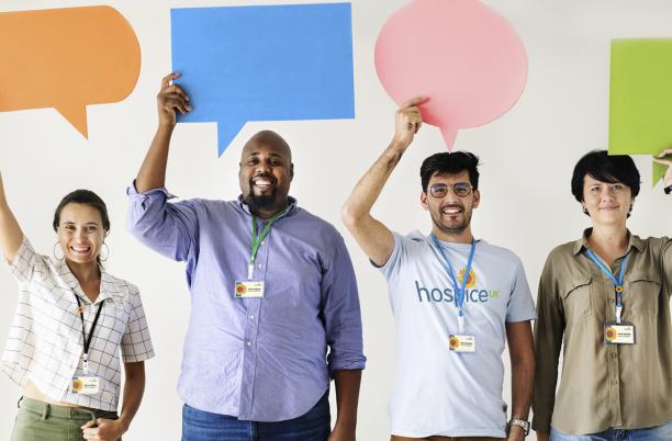 Four people holding up speech bubbles