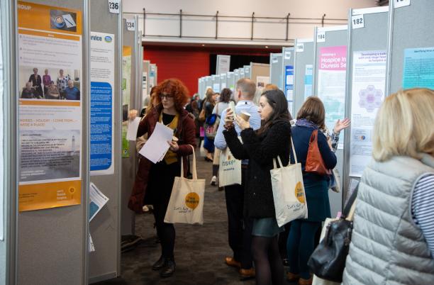 Delegates reviewing abstracts at the 2019 Hospice UK National Conference