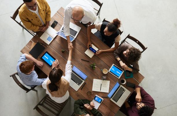 A stock photo from Pexels, overhead of a group of people collaborating across a table