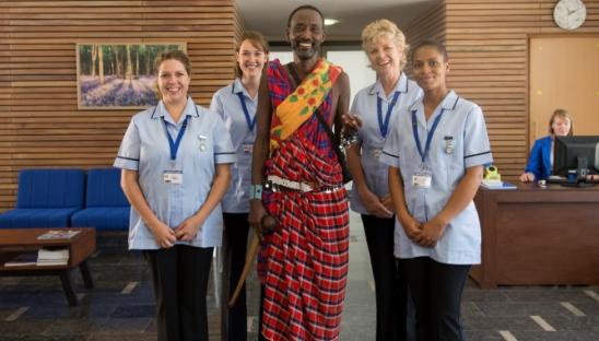 Members of the Co-operative Bank and nurses smiling at the camera