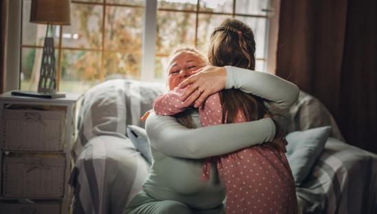 Woman hugging her granddaughter