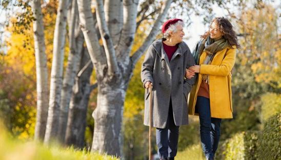 Two people walking outside in the autumn